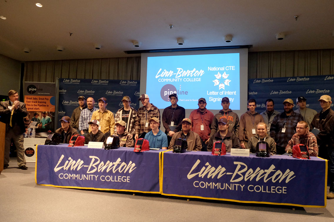 Students signing letters of acceptance to LBCC technical training programs.
